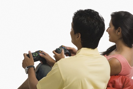 Couple playing a video game on a bean bag