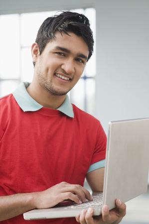 Portrait of a man using a laptopの写真素材