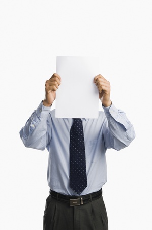 Businessman showing a sheet of blank paperの写真素材