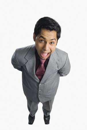 Portrait of a businessman making a funny faceの写真素材