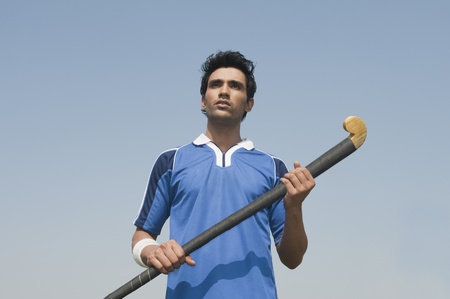Man holding a hockey stickの写真素材