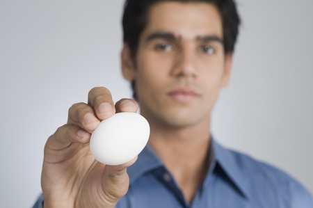 Man holding an eggの写真素材