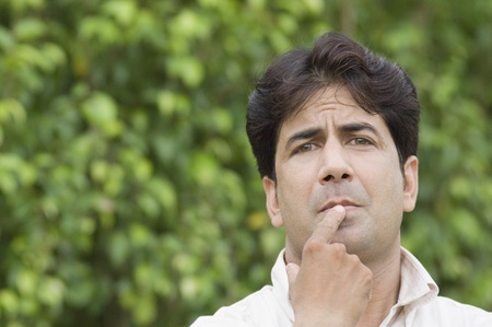 Portrait of a man thinking in a parkの写真素材