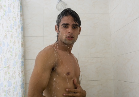 Close-up of a man taking a showerの写真素材