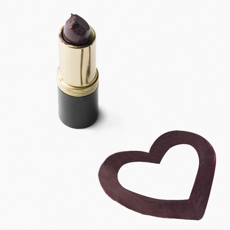 Close-up of a lipstick near  heart shape drawingの写真素材