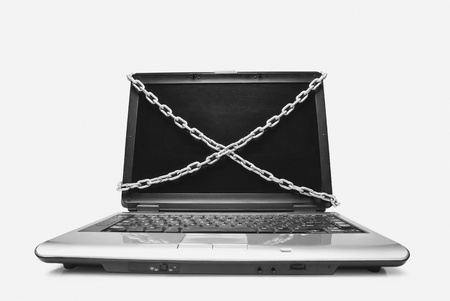 Close-up of a laptop tied with chainsの写真素材