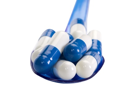 Close-up of a spoon with capsulesの写真素材