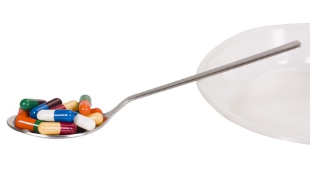 Close-up of a spoon with capsules