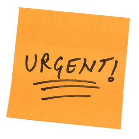 Word Urgent written on an adhesive noteの写真素材