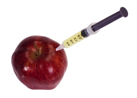 Syringe being injected into an appleの写真素材
