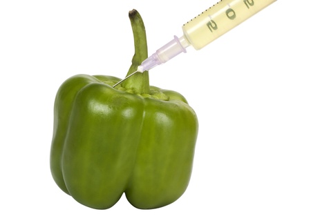 Green bell pepper being injected with a syringeの写真素材