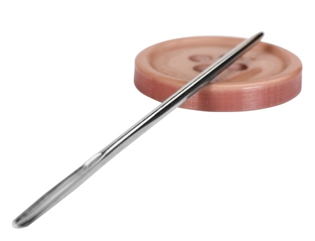 Close-up of a needle in the button hole