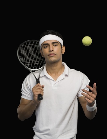 Tennis player with a tennis racket and a ballの写真素材