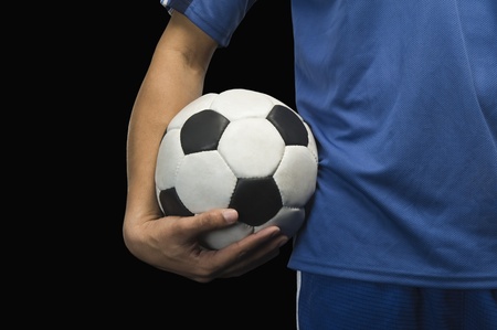 Mid section view of a soccer player with a soccer ballの写真素材