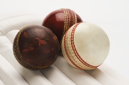 Close-up of cricket balls on cricket padsの写真素材