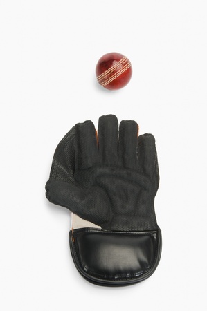 Close-up of a cricket ball and a wicket keeping gloveの写真素材