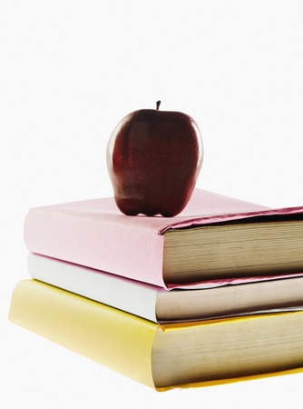 Apple on top of stacked booksの写真素材