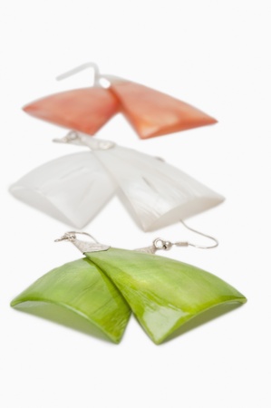 Close-up of three pairs of earrings representing Indian flag colorsの写真素材