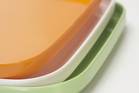 Close-up of a stack of colorful trays representing Indian flag colorsの写真素材