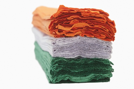 Close-up of a stack of colorful papers representing Indian flag colors