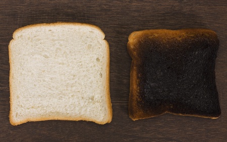Slice of a bread with a burnt toastの写真素材