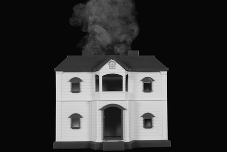 Smoke coming out from a model homeの写真素材