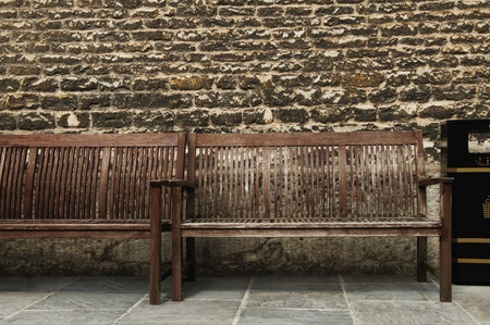 Benches in front of a weathered wall, Oxford, Oxfordshire, Englandの写真素材
