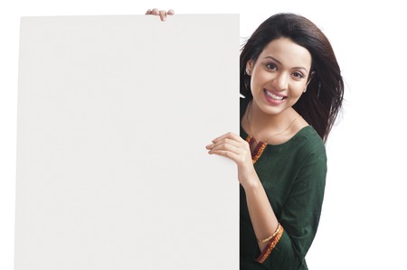 Portrait of a happy woman holding a whiteboardの写真素材