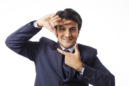 Businessman gesturing and smilingの写真素材