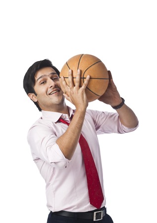 Businessman throwing a basketballの写真素材