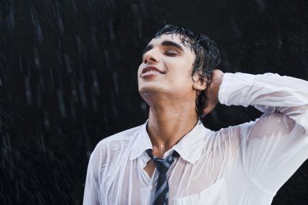 Businessman enjoying in the rainの写真素材