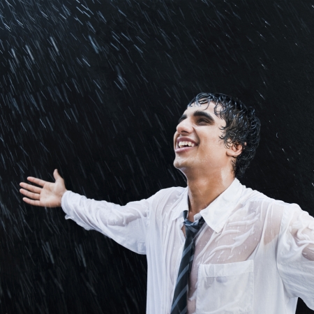 Businessman enjoying in the rainの写真素材