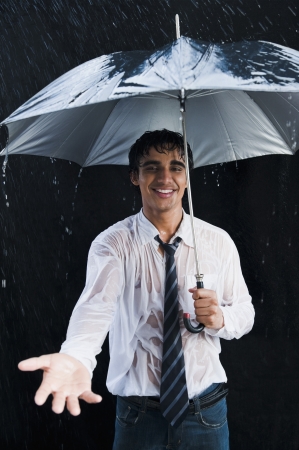 Businessman enjoying in the rainの写真素材