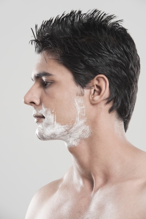 Man with shaving cream on his faceの写真素材