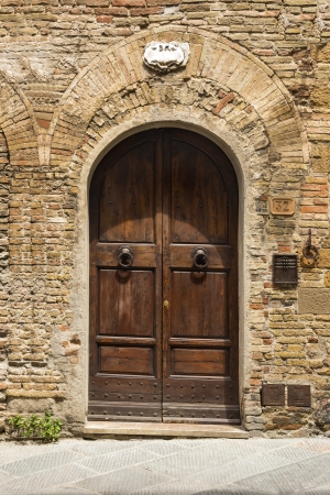 Closed door of a building in the medieval town of San Gimignano, Siena, Siena Province, Tuscany, Italyのeditorial素材