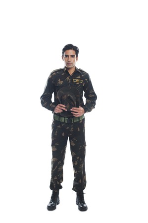 Portrait of an army soldier holding a capの写真素材