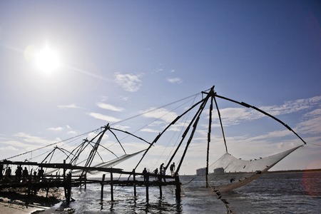 Fishermen with Chinese fishing nets at a harbor, Cochin, Kerala, Indiaのeditorial素材