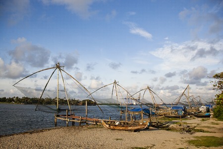 Chinese fishing nets and boats on the beach, Cochin, Kerala, Indiaの写真素材