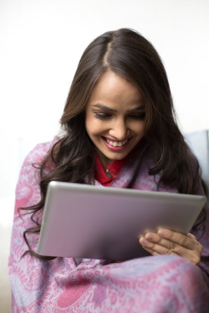 Woman using a digital tablet and smilingの写真素材