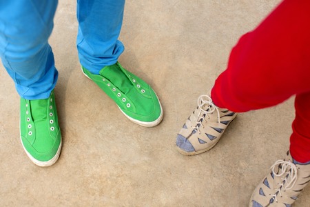 Low section view of two people wearing fashionable dressの写真素材