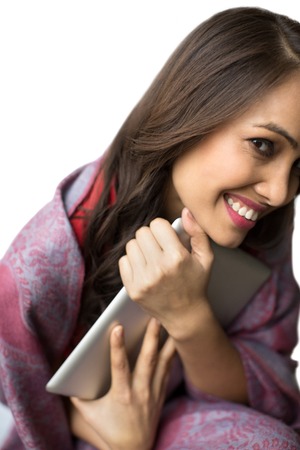 Portrait of a woman holding a digital tablet and smilingの写真素材