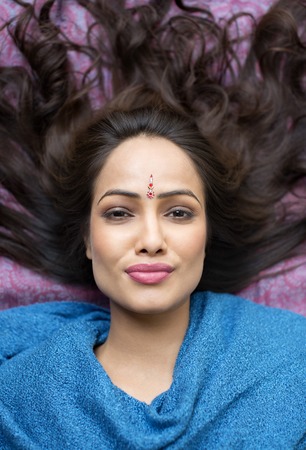 Portrait of a woman lying down and smilingの写真素材