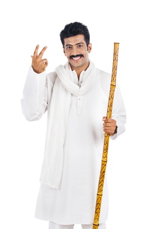 Portrait of a man holding a wooden staff and smilingの写真素材