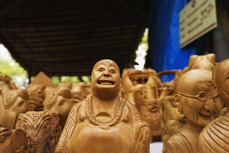 Statues of Laughing Buddha for sale at souvenir shopの写真素材