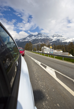Cars moving on the road in the valley, St. Moritz, Italyのeditorial素材