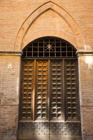 Closed door of a building, Siena, Siena Province, Tuscany, Italyの写真素材