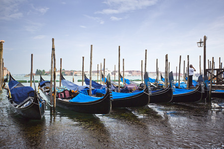 Gondolas moored at dock, Venice, Veneto, Italyの写真素材