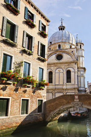 Bridge over a canal with a church , Venice, Veneto, Italyの写真素材
