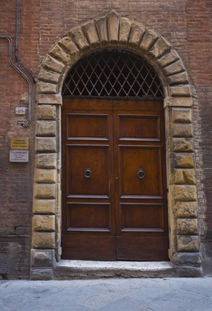Closed door of a building, Siena, Siena Province, Tuscany, Italyの写真素材