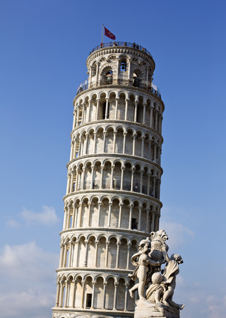 Statue in front of a tower, La Fontana dei Putti Statue, Leaning Tower of Pisa, Piazza dei Miracoli, Pisa, Tuscany, Italyの写真素材